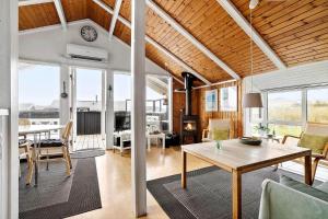 a living room with a table and a dining room at LK1247-Lokken-Falkevej-3 in Løkken +19 photos