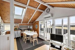 a dining room and kitchen with a table and chairs at LK1247-Lokken-Falkevej-3 in Løkken