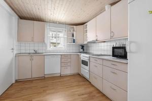 una cucina con armadietti bianchi ed elettrodomestici bianchi di LK551-Lokken-Houmannsvej-17 a Løkken Altre 11 foto