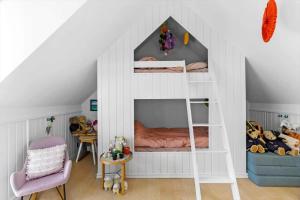 a room with a white bunk bed with a ladder at LK1926-Lokken-Vittrupsvej-1 in Løkken