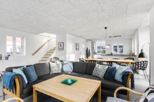 a living room with a couch and a table at LK1294-Lokken-Josefines-Have-123 in Løkken
