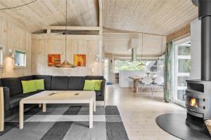 a living room with a couch and a fireplace at LK626-Lokken-Magdalenevej-40 in Løkken