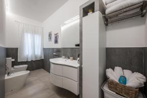 Un baño blanco con lavabo e inodoro. en La Maisonette del Crist0, en Sorbara 21 fotos más