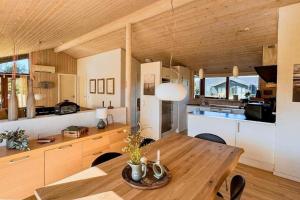 a kitchen and dining room with a wooden table at LK537-Lokken-Mievej-20 in Løkken