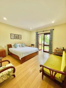 クイニョンにあるHaven Boutique Hotel Quy Nhonの広いベッドルーム(ベッド1台、ソファ付)
