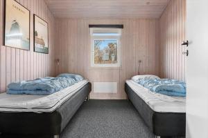 two beds in a room with a window at LK2129-Lokken-Diget-18 in Løkken +12 photos
