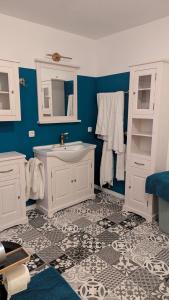 a bathroom with a white sink and blue walls at Pferdeparadies Stein 