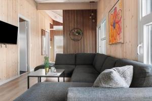 a living room with a couch and a table at LK2129-Lokken-Diget-18 in Løkken
