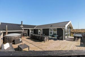 a house with a deck with a gazebo at LK2129-Lokken-Diget-18 in Løkken