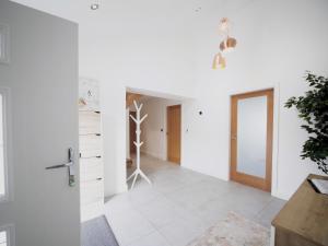 a hallway with white walls and a door to a room at Pass the Keys Luxury Property with Stunning View in Bodorgan +21 photos