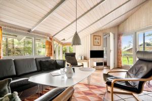 a living room with a couch and a table at LK599-Lokken-Stellavej-16 in Løkken
