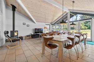 a dining room with a table and chairs and a fireplace at LK1807-Lokken-Marthasvej-3 in Løkken