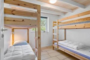 a bedroom with two bunk beds in a house at LK1807-Lokken-Marthasvej-3 in Løkken