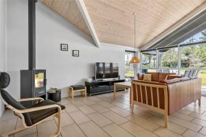 a living room with a couch and a fireplace at LK1807-Lokken-Marthasvej-3 in Løkken