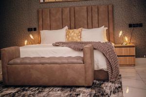 a bedroom with a large bed and a couch at FraMMa Homes in Akure +80 photos