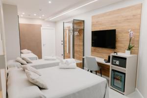 ペスカーラにあるStella D'Oro Roomsのデスク、テレビが備わる客室で、ベッド2台を利用できます。