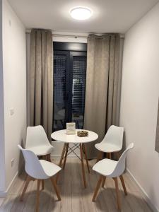 a table and chairs in a room with a window at Marina LUX in Igalo
