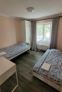 a room with two beds and a window at Vila KEDAR sa klimom in Kragujevac