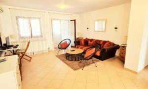 a living room with a couch and a table and chairs at Apartment 5237-2 in Batalaži