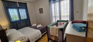 a small bedroom with a bed and a baby crib at Apartment 5237-2 in Batalaži +20 photos