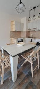 una cocina con una gran mesa blanca y sillas en Lighthouse GbA 304, en Balchik