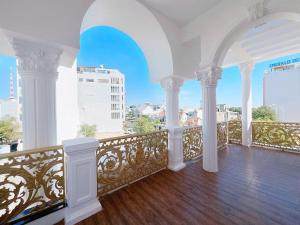 a white balcony with a view of a city at Villa Thái An in Phan Thiet