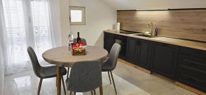 a kitchen with a table with chairs and a sink at Apartment 5237-3 in Batalaži