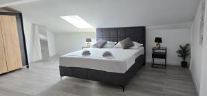 a bedroom with a large bed in a room at Apartment 5237-3 in Batalaži