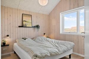 a bedroom with a bed and a window at 244-Harboore-Knaresbrovej-17 in Harboør