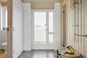 a straw hat sitting on a table in a bathroom at 115-Harboore-Strandvejen-164 in Harboør +18 photos