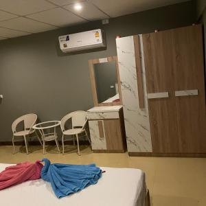 a hospital room with a bed and chairs and a mirror at Saran Hotel krabi Thailand in Krabi +224 photos