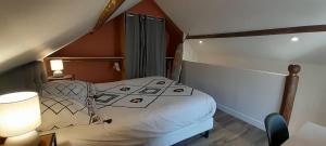 a bedroom with a bed in a small room at Joli duplex centre ville terrasse wifi clim in Châteauroux