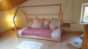 a bedroom with a canopy bed in a room at La Petite Maison in Orgueil