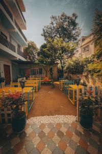 a group of tables and benches in a courtyard at Flying Dutchman Hostel in Varanasi +42 photos