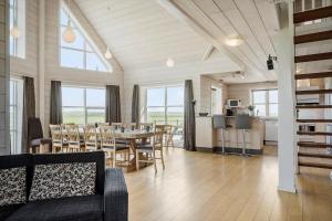 a living room with a table and chairs and a kitchen at 289-Harboore-Strandvejen-179 in Harboør