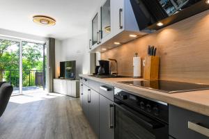 a kitchen with a stove and a counter top at Wellenzauber in Kellenhusen