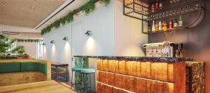 a bar in a restaurant with a green counter at Hotel Ben Marsalforn, Affiliated by Meliá in Marsalforn