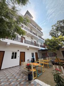 a building with a table and chairs in front of it at Flying Dutchman Hostel in Varanasi