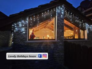 a building with christmas lights in the window at BAITA LOVELY AND CENTRAL SAUZE D'OULX in Sauze dʼOulx