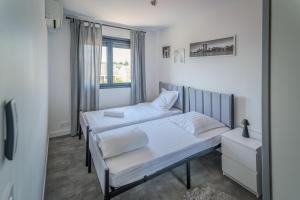 a bedroom with two beds and a window at Un havre de Paix entre Paris et Disney in Le Plessis-Trévise