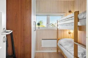 a small bedroom with a bunk bed and a window at G139-Lemvig-Porsevej-39 in Lemvig