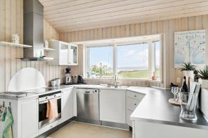 a kitchen with white appliances and a window at G326-Lemvig-Skovstjernevej-26 in Lemvig +17 photos