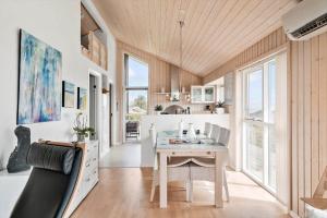a kitchen with a table and a dining room at G326-Lemvig-Skovstjernevej-26 in Lemvig
