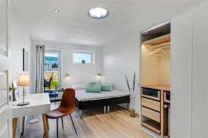 a small bedroom with a bed and a desk and a desk at 712-Thyboron-Vesterhavsgade-30 in Thyborøn