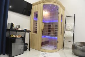 a shower with a glass door in a bathroom at Room 84 in Poggiomarino
