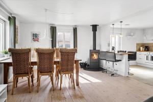 a dining room with a table and chairs and a fireplace at 704-Thyboron-Kirkevej-6 in Thyborøn
