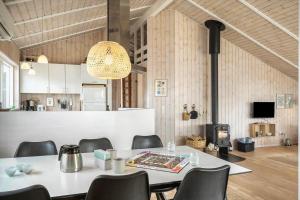 a dining room with a table and chairs and a stove at 528-Lemvig-Stranden-22 in Lemvig