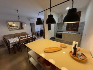 a kitchen and living room with a table and a dining room at Il Tramonto di Pienza in Pienza