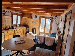 a kitchen and a table in a tiny house at Gîte de l Auguille in Megève