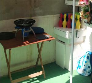 a room with a table with a grill and vases at Casa del Centro PT in Santa Caterina Villarmosa